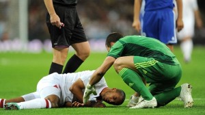Down and out: Theo Walcott injured following a collision with the keeper