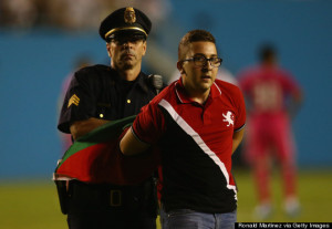 Police haul away one of the many pitch invaders from the AS Roma-Real Madrid friendly in Dallas.