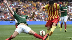 Aymeric Laporte (left) tackling Lionel Messi of Barcelona